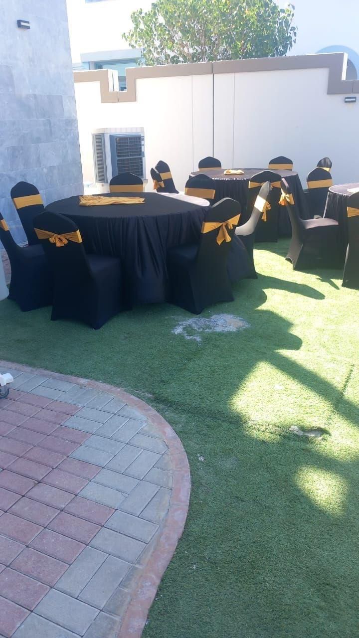 Banquet tables covered in black linen for event rental